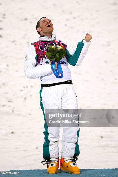 Silver medalist David Morris of Australia celebrates during the flower ceremony for the Freestyle Skiing Men's Aerials Finals on day ten of the 2014...