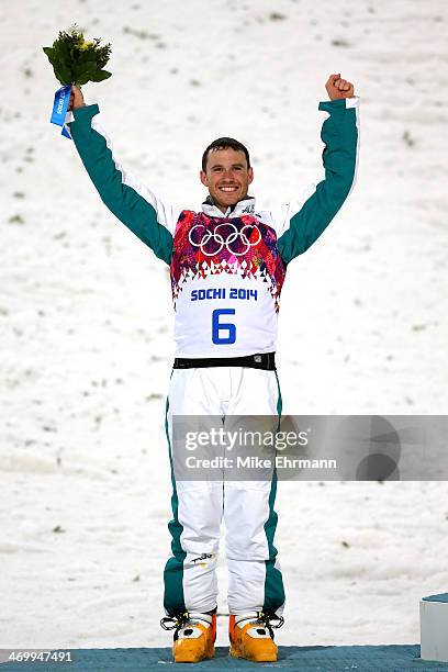 Silver medalist David Morris of Australia celebrates during the flower ceremony for the Freestyle Skiing Men's Aerials Finals on day ten of the 2014...