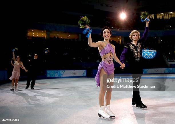 Gold medalists Meryl Davis and Charlie White of the United States celebrate during the flower ceremony for the Figure Skating Ice Dance on Day 10 of...