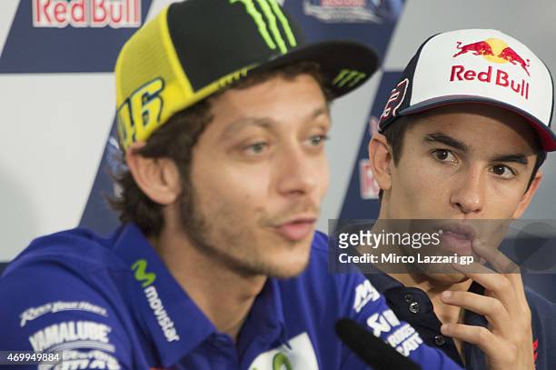 Marc Marquez of Spain and Repsol Honda Team watches Valentino Rossi of Italy and Movistar Yamaha MotoGP during a press conference during the MotoGp...
