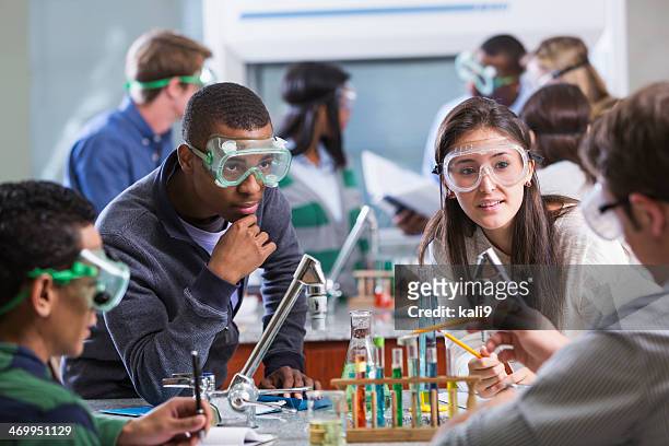 group of multi-ethnic students in chemistry lab - high school stock pictures, royalty-free photos & images