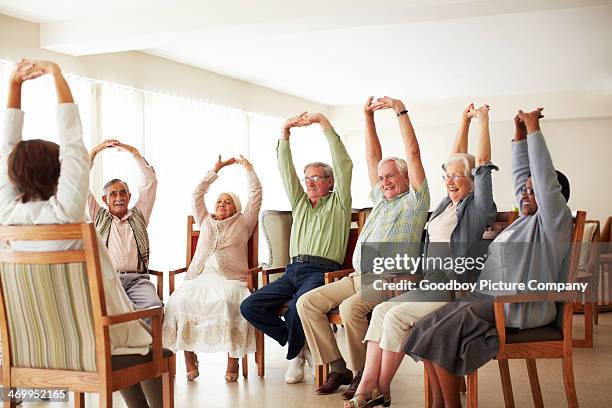 doing some group exercises - exercise class stock pictures, royalty-free photos & images