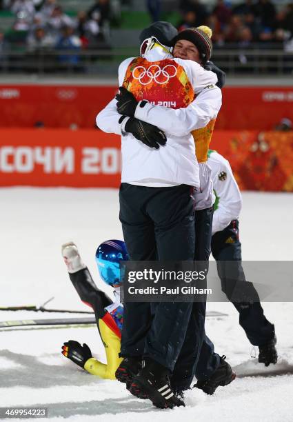 Andreas Wank of Germany celebrates with team-mate Marinus Kraus during the Men's Team Ski Jumping final round on day 10 of the Sochi 2014 Winter...