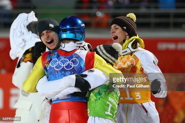 Severin Freund of Germany is mobbed by team-mates after the Men's Team Ski Jumping final round on day 10 of the Sochi 2014 Winter Olympics at the...