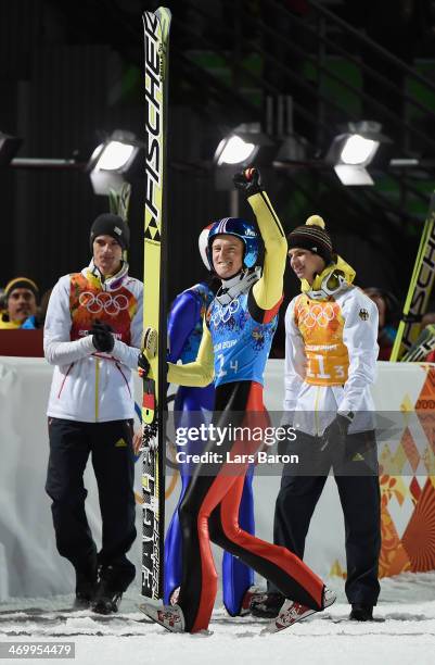 Severin Freund of Germany celebrates with his team-mates after the Men's Team Ski Jumping final round on day 10 of the Sochi 2014 Winter Olympics at...