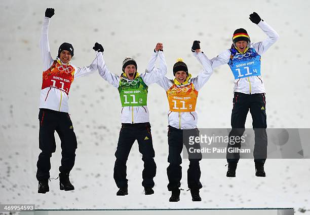 Gold medalists Andreas Wank, Marinus Kraus, Andreas Wellinger and Severin Freund of Germany celebrate during the flower ceremony for the Men's Team...