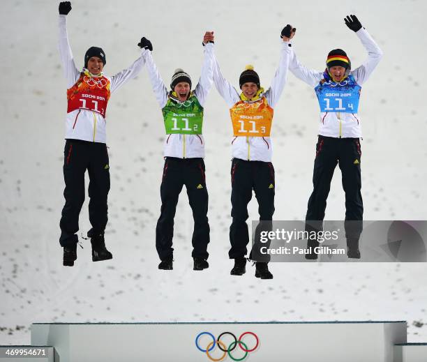 Gold medalists Andreas Wank, Marinus Kraus, Andreas Wellinger and Severin Freund of Germany celebrate during the flower ceremony for the Men's Team...