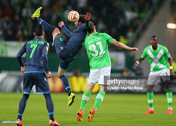 Gonzalo Higuaín of Napoli jumps with Robin Knoche of VfL Wolfsburg during the UEFA Europa League Quarter Final first leg match between VfL Wolfsburg...