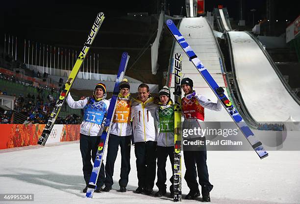 Gold medalists Andreas Wank, Marinus Kraus, Andreas Wellinger and Severin Freund of Germany celebrate with Alfons Hoermann, DOSB president after the...