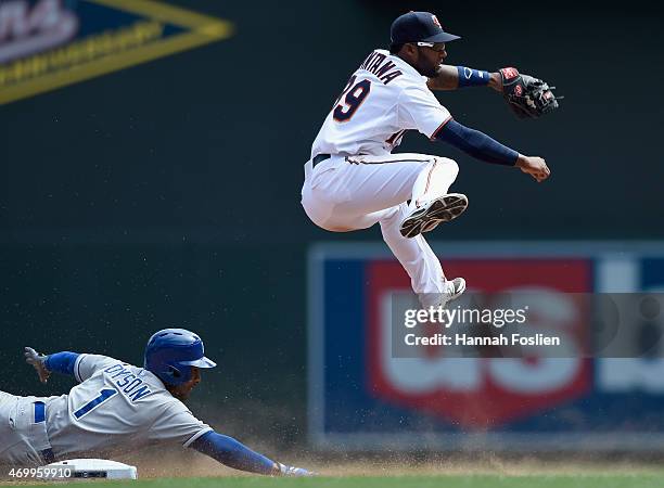 Jarrod Dyson of the Kansas City Royals is out at second base as he breaks up a double play attempt by Danny Santana of the Minnesota Twins during the...