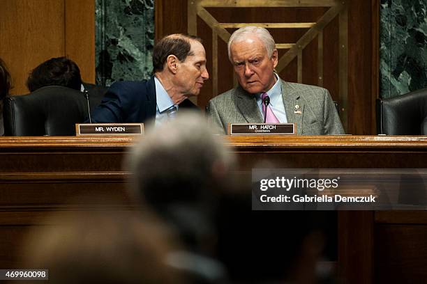 Ranking Member Ron Wyden , left, and Chairman Orrin Hatch , right, speak during the Senate Finance Committee hearing on Congress and U.S. Tariff...