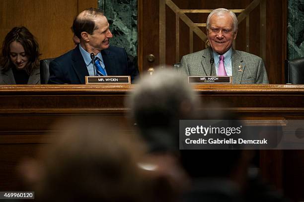 Ranking Member Ron Wyden , left, and Chairman Orrin Hatch , right, speak during the Senate Finance Committee hearing on Congress and U.S. Tariff...