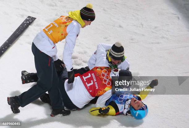 Severin Freund of Germany is mobbed by team-mates after the Men's Team Ski Jumping final round on day 10 of the Sochi 2014 Winter Olympics at the...