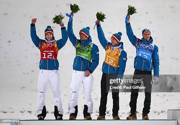 Silver medalists Michael Hayboeck, Thomas Morgenstern, Thomas Diethart and Gregor Schlierenzauer of Austria celebrate during the flower ceremony for...