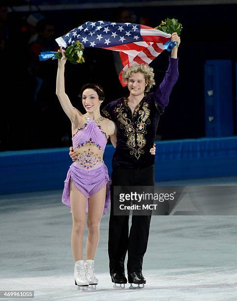 Ice dancing gold medalists Meryl Davis and Charlie White of he USA take a victory lap with an American flag following the flower ceremony at the...