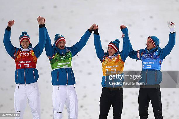 Silver medalists Michael Hayboeck, Thomas Morgenstern, Thomas Diethart and Gregor Schlierenzauer of Austria celebrate during the flower ceremony for...