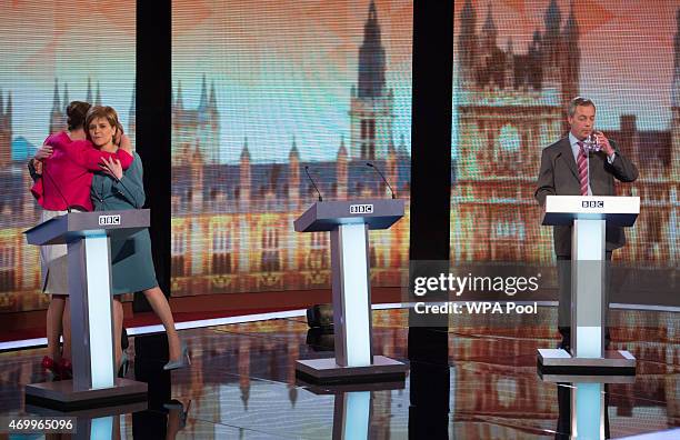 Plaid Cymru leader Leanne Wood, Green Party Leader Natalie Bennett andSNP leader Nicola Sturgeon share a hug UKIP leader Nigel Farage sips his drink...