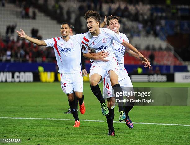Denis Suarez of Sevilla celebrates with team mates as he scores their second goal during the UEFA Europa League Quarter Final first leg match between...