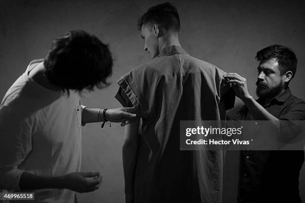 Jose Alfredo Silva and Giovanni Estrada, fashion designers of Simple by Trista, work with a model during the fitting test previous to the...