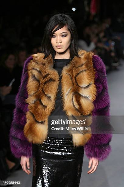 Model Chiharu Okunugi walks the runway at the TOM FORD show at London Fashion Week AW14 at The Lindley Hall on February 17, 2014 in London, England.
