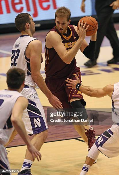 Elliott Eliason of the Minnesota Golden Gophers moves against Alex Olah of the Northwestern Wildcats at Welsh-Ryan Arena on February 16, 2014 in...