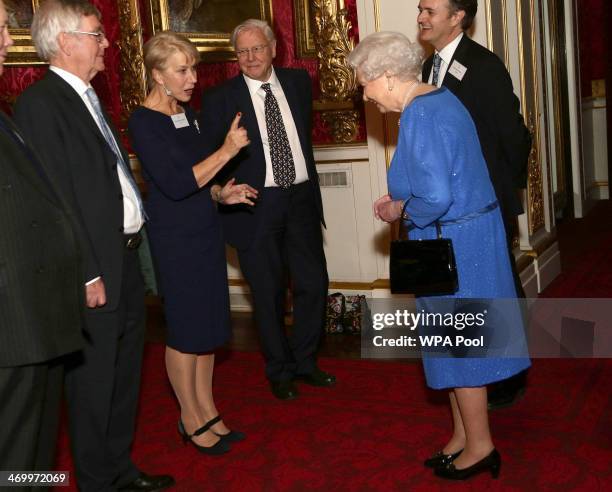 Queen Elizabeth II meets actress Dame Helen Mirren the Dramatic Arts reception at Buckingham Palace on February 17, 2014 in London, England.