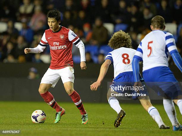 Ryo Miyaichi of Arsenal runs at Aaron Kuhl and Pierce Sweeney of Reading during the Barclays U21 Premier League match between Reading U21 and Arsenal...