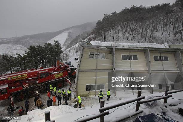 Rescue workers search for survivors from a collapsed resort gymnasium on February 18, 2014 in Gyeongju, South Korea. A resort building in the...