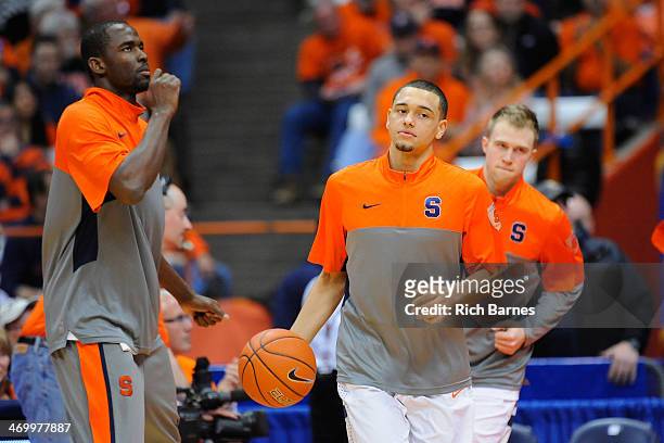 Baye Moussa Keita, Tyler Ennis and Trevor Cooney of the Syracuse Orange jog on the court prior to the game against the North Carolina State Wolfpack...