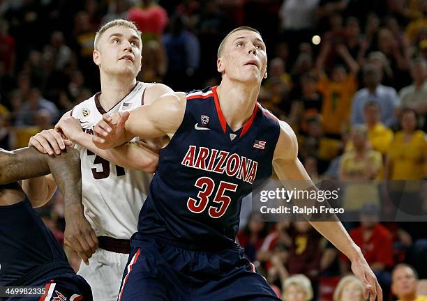 Kaleb Tarczewski of the Arizona Wildcats and Jonathan Gilling of the Arizona State Sun Devils battle for position under the basket during the second...