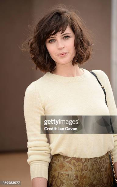 Felicity Jones arrives at Burberry Womenswear Autumn/Winter 2014 at Kensington Gardens on February 17, 2014 in London, England.