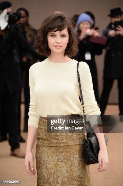 Felicity Jones arrives at Burberry Womenswear Autumn/Winter 2014 at Kensington Gardens on February 17, 2014 in London, England.