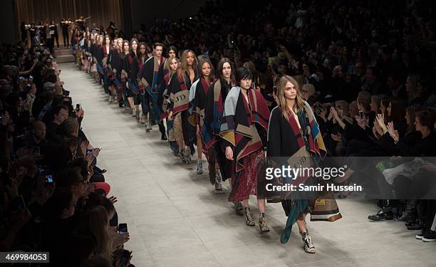 Cara Delevingne and models walk the runway with models at the Burberry Prorsum show at Perks Field during London Fashion Week AW14 in at the...