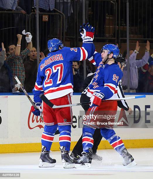 Ryan McDonagh of the New York Rangers scores a powerplay goal at 15:16 of the first period against the Pittsburgh Penguins and is joined by Keith...