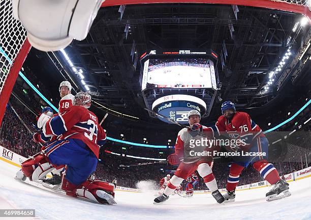 Carey Price and P.K. Subban of the Montreal Canadiens defend the goal against Joakim Andersson of the Detroit Red Wings in the NHL game at the Bell...