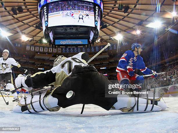 Derick Brassard of the New York Rangers scores at 28 seconds of the first period against Marc-Andre Fleury of the Pittsburgh Penguins in Game One of...