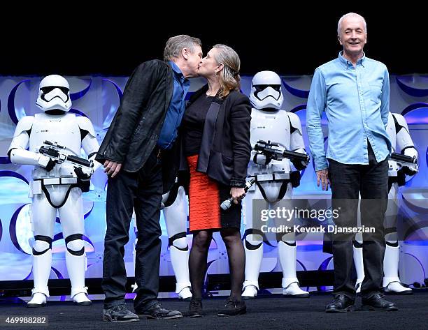 Cast members of the original "Star Wars" film Mark Hamill and Carrie Fisher kiss as Anthony Daniels looks on during the kick-off event of Disney's...