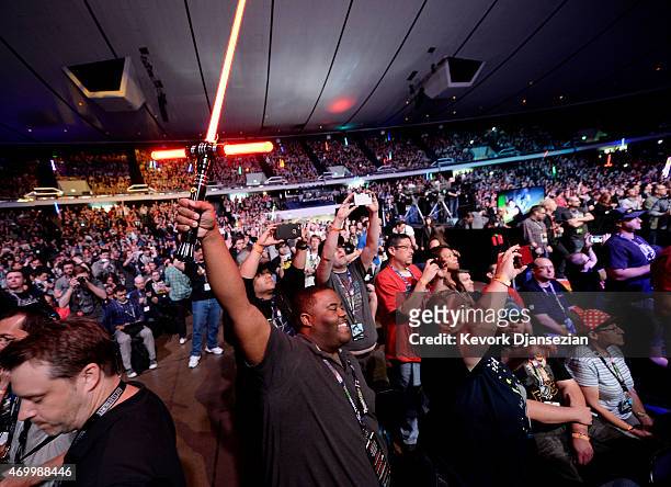 Fan holds up a "Star Wars" lightsaber at the kick-off event of Disney's Star Wars Celebration 2015 at the Anaheim Convention Center April 16, 2015....