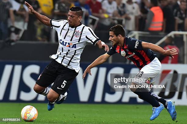 Ralf of Brazils Corinthians, vies for the ball with Sebastian Blanco of Argentina's San Lorenzo, during their 2015 Copa Libertadores football match...