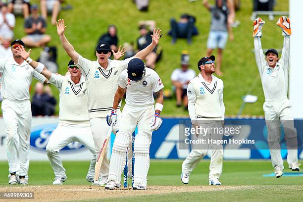 Virat Kohli of India stands his ground as Peter Fulton, Corey Anderson, James Neesham, Brendon McCullum and BJ Watling of New Zealand appeal...