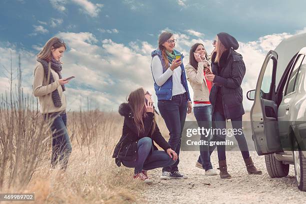 group of friends with vehicle breakdown, on the phone - broken friendship stock pictures, royalty-free photos & images