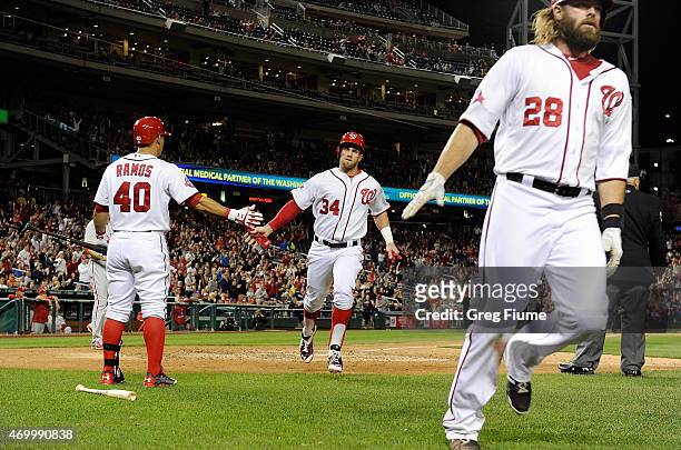Bryce Harper and Jayson Werth of the Washington Nationals score in the sixth inning against the Philadelphia Phillies at Nationals Park on April 16,...