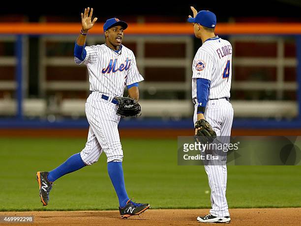 Curtis Granderson and Wilmer Flores of the New York Mets celebrate the 7-5 win over the Miami Marlins on April 16, 2015 at Citi Field in the Flushing...