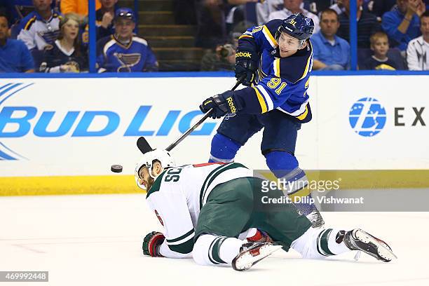 Vladimir Tarasenko of the St. Louis Blues shoots the puck over Charlie Coyle of the Minnesota Wild during Game One of the Western Conference...