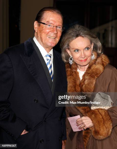 Sir Roger Moore and Kristina Tholstrup attend a Dramatic Arts reception hosted by Queen Elizabeth II at Buckingham Palace on February 17, 2014 in...