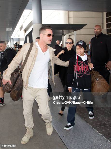 Brad Pitt, Angelina Jolie, and their son Maddox Jolie-Pitt are seen at Los Angeles International airport on February 17, 2014 in Los Angeles,...