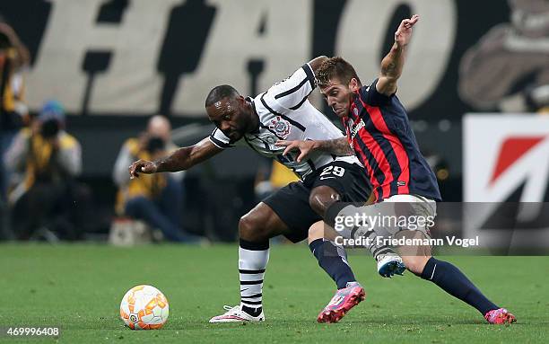 Vagner Love of Corinthians fights for the ball with Julio Buffarini of San Lorenzo during a match between Corinthians and San Lorenzo as part of...