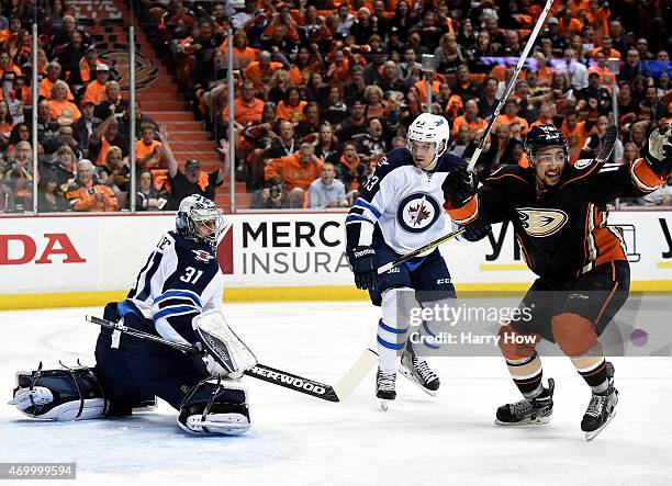 Ondrej Pavelec and Ben Chiarot of the Winnipeg Jets and Emerson Etem of the Anaheim Ducks react to a goal by Sami Vatanen during the first period in...