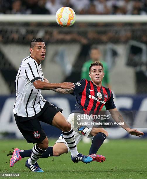 Ralf of Corinthians fights for the ball with Julio Buffarini of San Lorenzo during a match between Corinthians and San Lorenzo as part of Group 2 of...