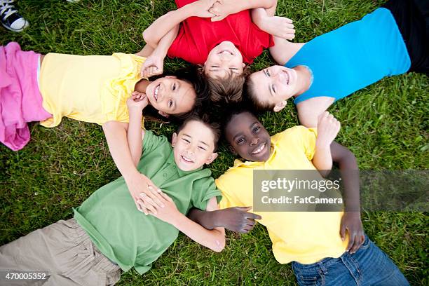 group of children in a circle - circle of heads stock pictures, royalty-free photos & images